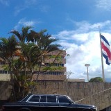 COSTA-RICA-BUILDING-WITH-A-FLAG-AND-LIMOUSINE-MERCEDES-300D